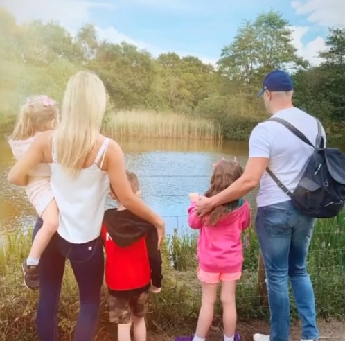 Christine McGuinness and her children Leo and Penelope looking at a lake.