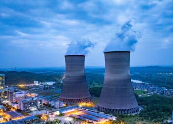 Thermal nuclear power plant cooling towers at dusk.