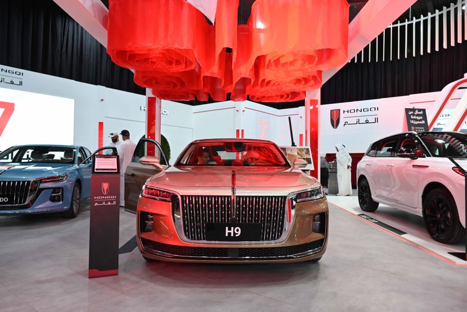 Visitors sit inside a Hongqi H9 vehicle at the Auto World Show in Kuwait.