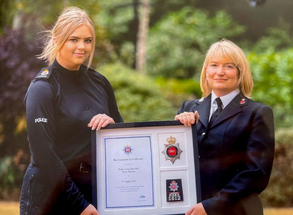 Hannah Byrne and her mother Sarah at Sarah's retirement ceremony, holding her retirement certificate and police badge.