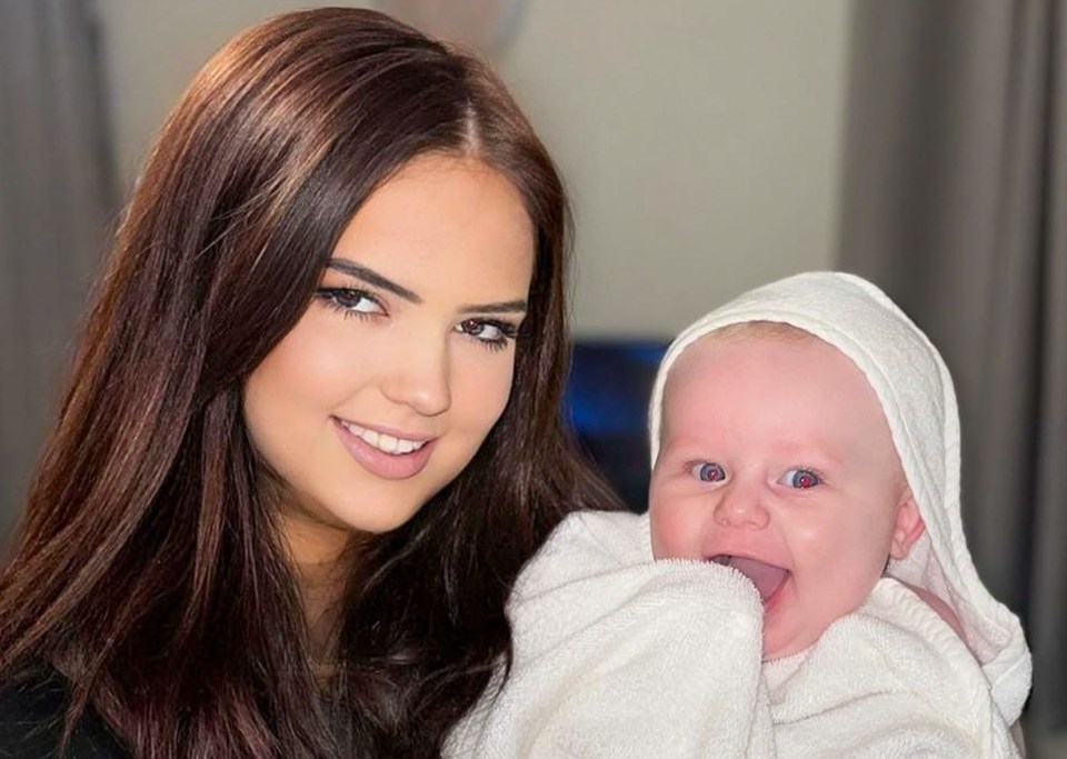 Hannah Byrne smiling while holding her infant nephew Jensen.