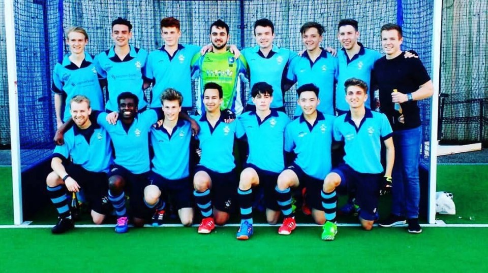 Nick Barnard (standing, second from right, in black shirt and blue jeans) with his hockey team.