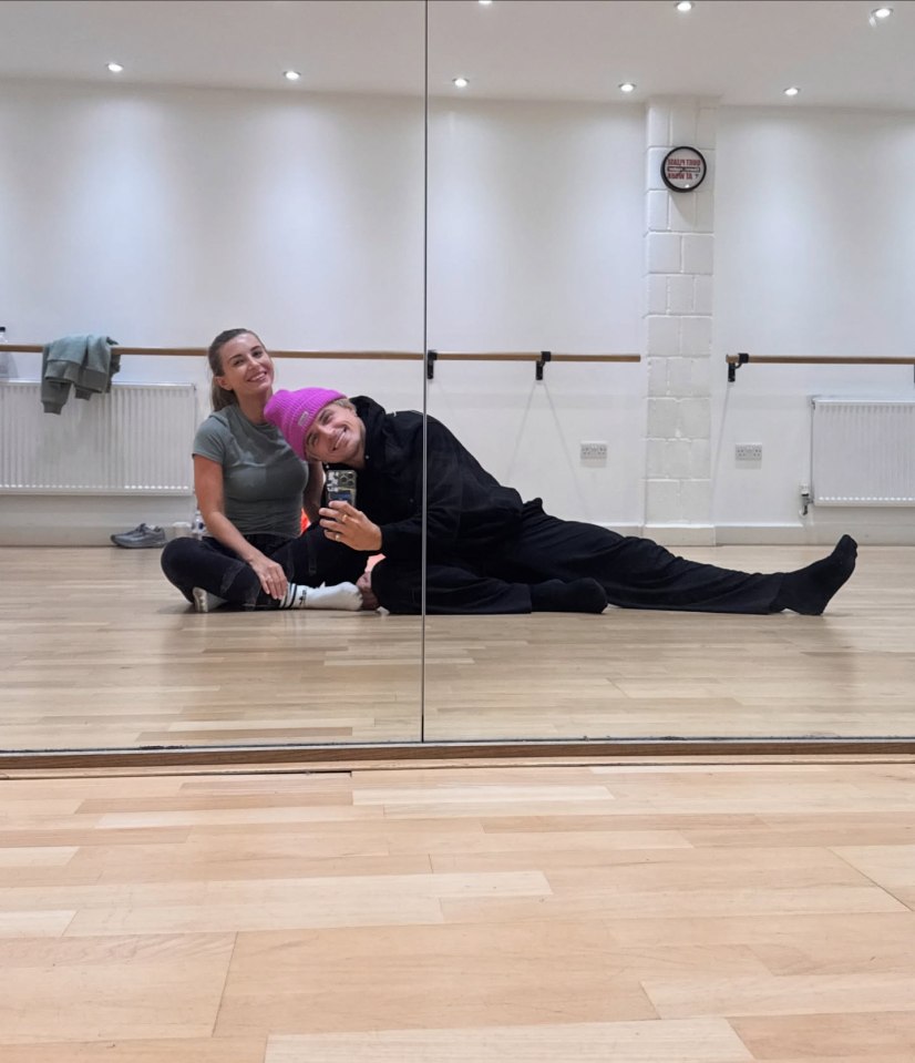 Nikita Kuzmin and Dani Dyer posing for a selfie in a dance studio.