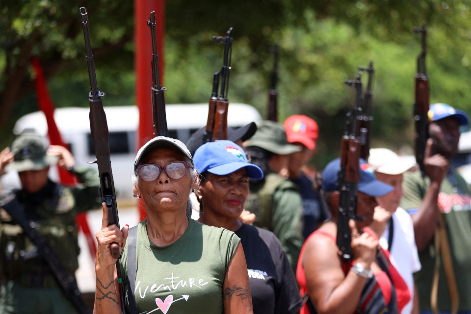 People hold rifles during military training.