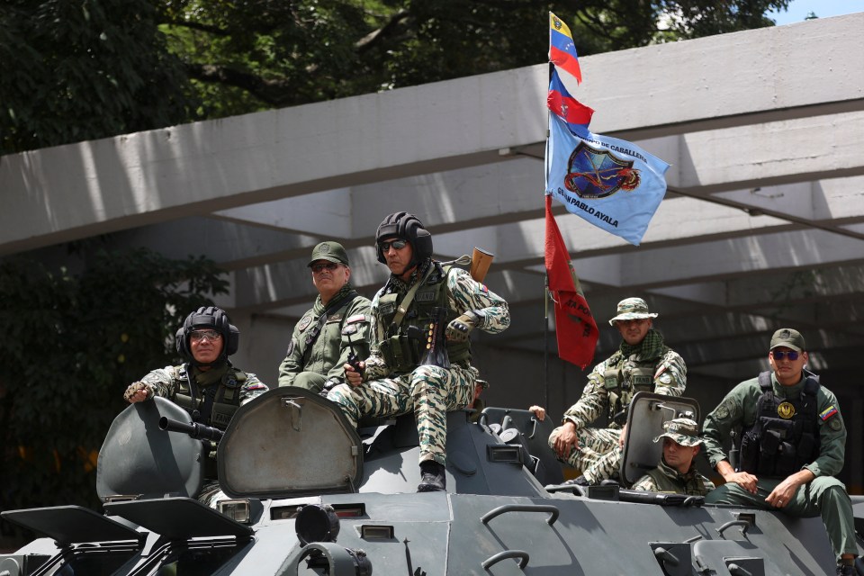 Venezuelan Defense Minister Vladimir Padrino Lopez and soldiers on a tank during a military exercise.