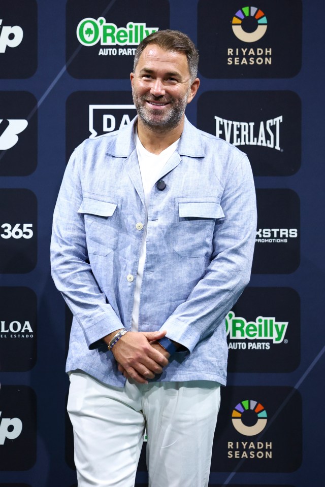 Eddie Hearn, Chairman of Matchroom Sport, smiling during a weigh-in.
