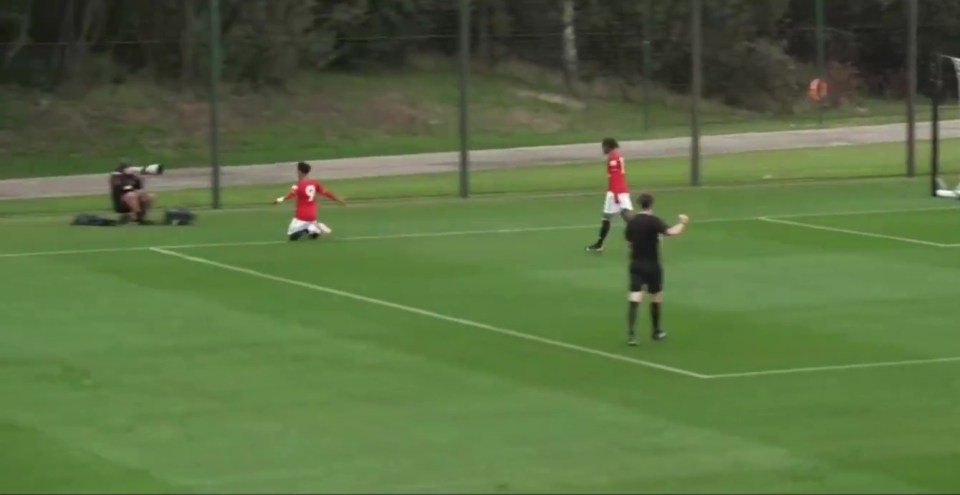 JJ Gabriel on his knees celebrating a goal for Manchester United's U18 team.