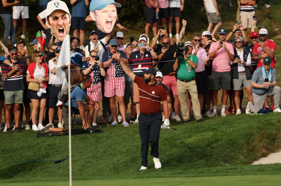 Golfer Rahm attempts a shot from the sand trap during a Ryder Cup match.