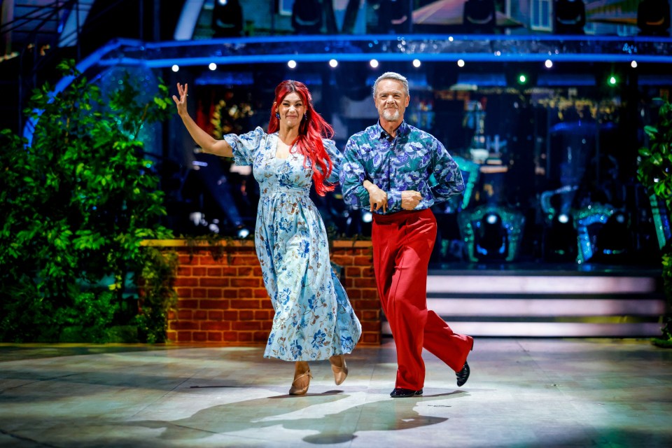 Two dancers performing on stage during a live show.