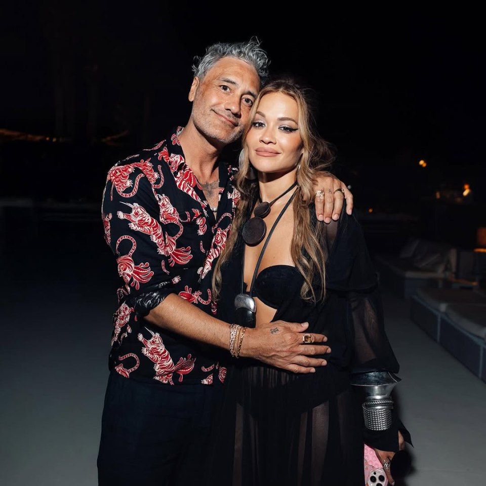 Taika Waititi and Rita Ora pose for a photo.