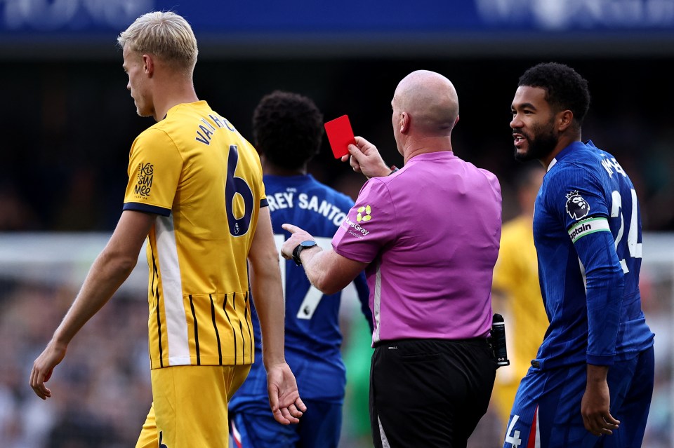 Reece James talks to Referee Simon Hooper as he shows a red card to a player.