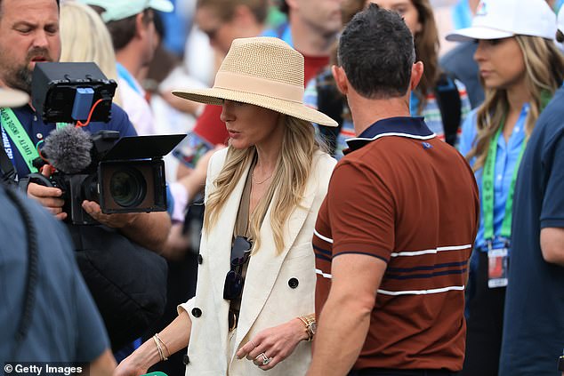 She was waiting by the 18th green for McIlroy after he won Europe a precious point