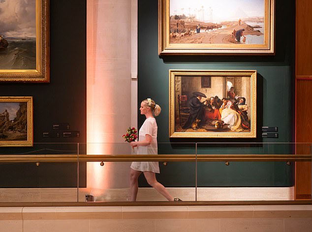 A model is pictured at the Guildhall Art Gallery in London, showcasing pre-loved wedding wear