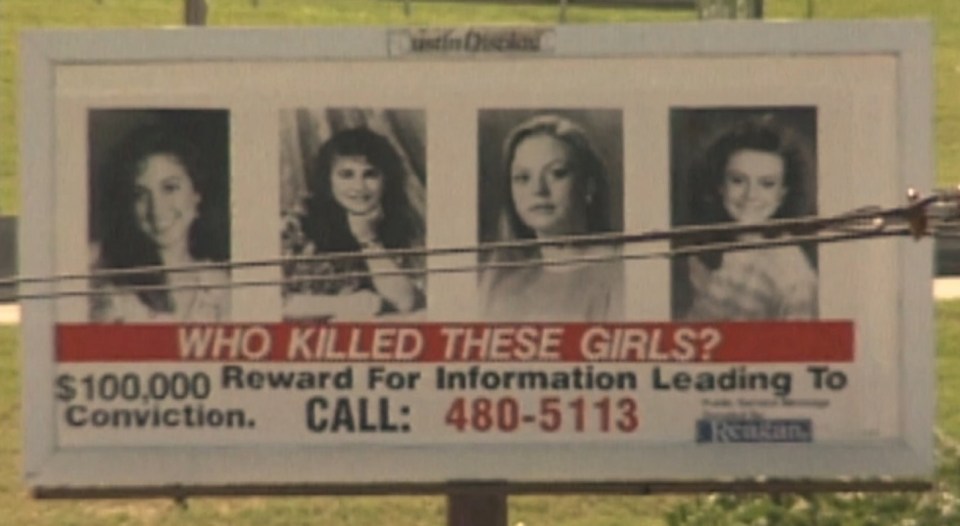 Billboard with portraits of four young women, asking "Who killed these girls?" and offering a $100,000 reward for information.
