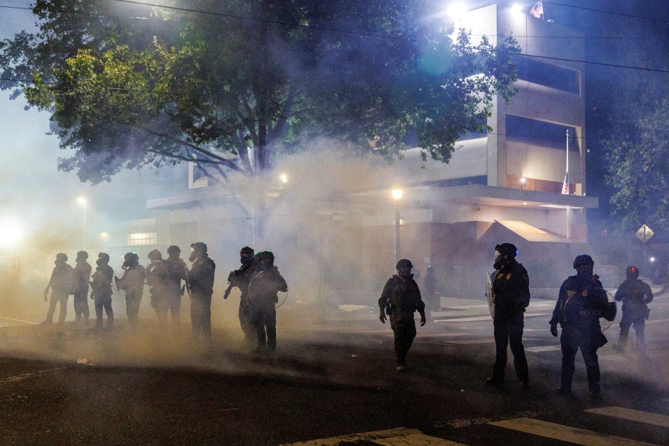 Tear gas and smoke envelop ICE agents during a protest against the U.S. President Donald Trump administration's immigration policies, outside an ICE detention facility in Portland, Oregon.