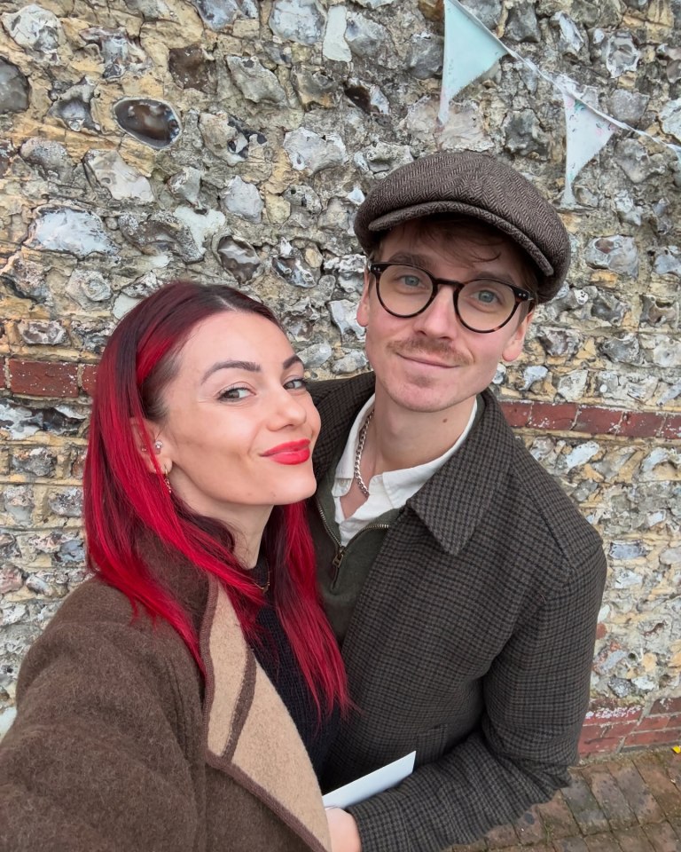Dianne Buswell and Joe Sugg smiling at the camera.