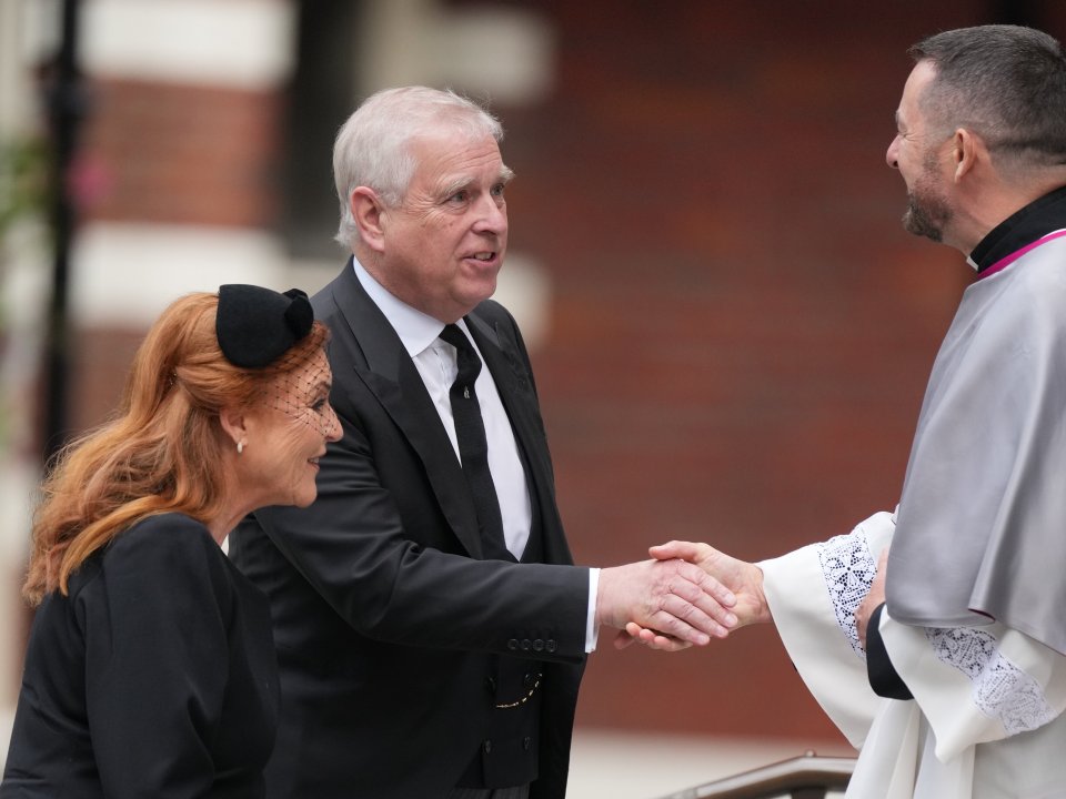 Prince Andrew shakes hands with a clergyman, with Sarah, Duchess of York, smiling beside him, at the funeral of the Duchess of Kent.