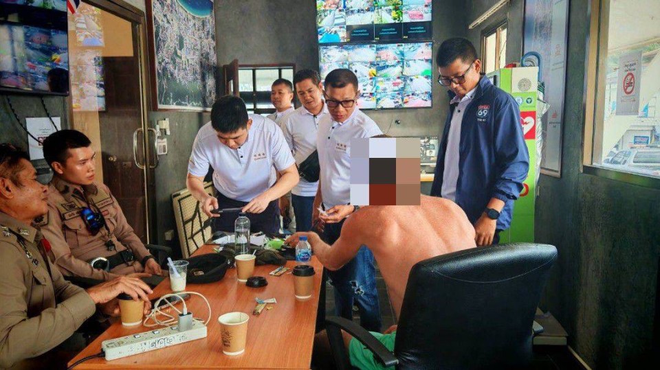 Aidan Jesse Phillimore, 44, being questioned by police officers and other individuals.