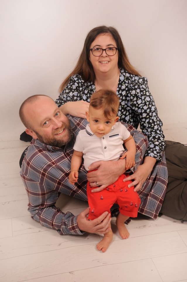 Natasha, Nick, and Harry Hewitt pose for a family photo.