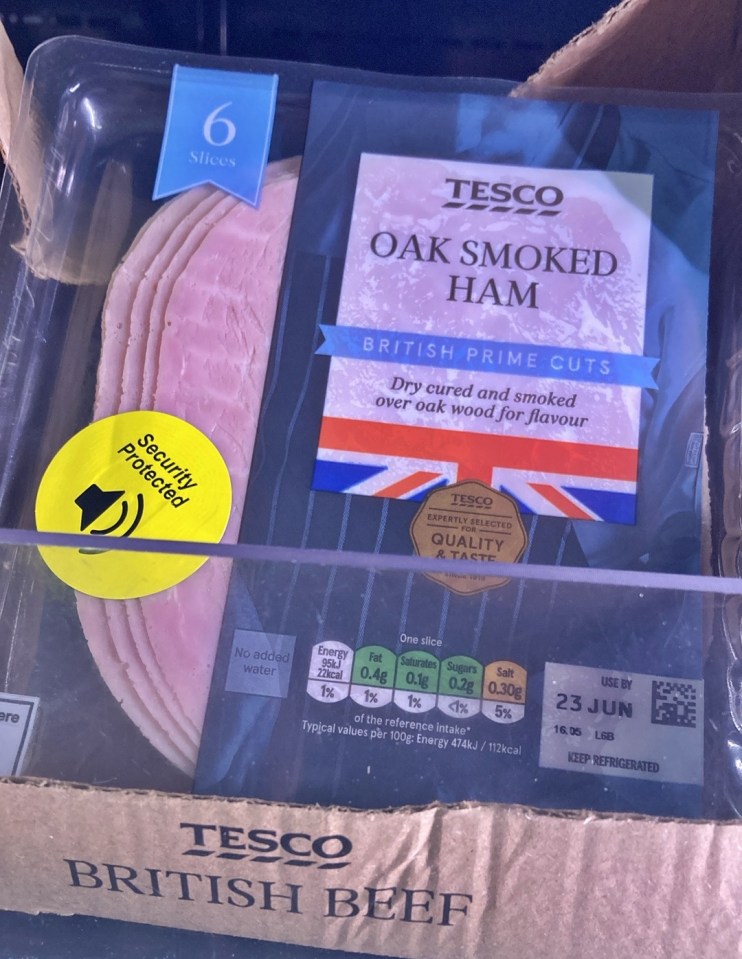 A package of Tesco Oak Smoked Ham with a "Security Protected" sticker on it.