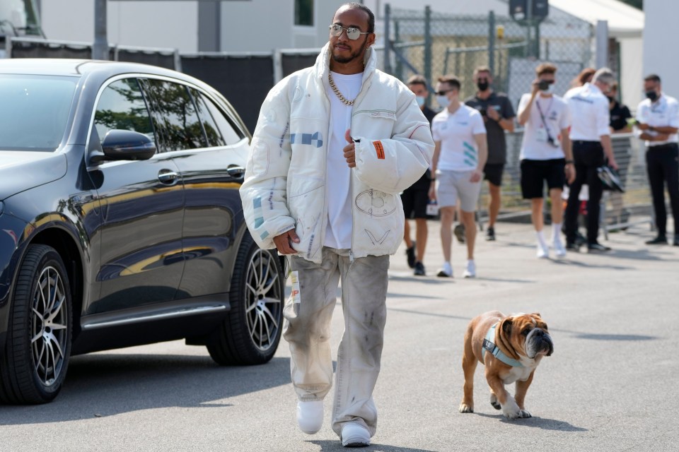 Lewis Hamilton walking his dog Roscoe at the Monza racetrack.