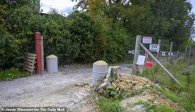 The disputed driveway entrance where twin red metal fenceposts were installed by David McCorquodale and one on the right-hand side was cut down, sparking confrontation