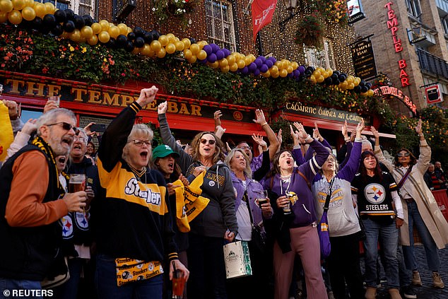 Steelers and Vikings fans cheer outside the famous Temple Bar in the center of Dublin