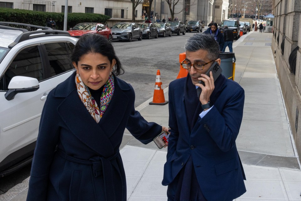 Pawan Passi, former equities executive at Morgan Stanley, talking on the phone while leaving court with a woman.