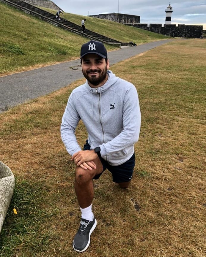 Kieran Magee doing a lunge exercise outdoors.