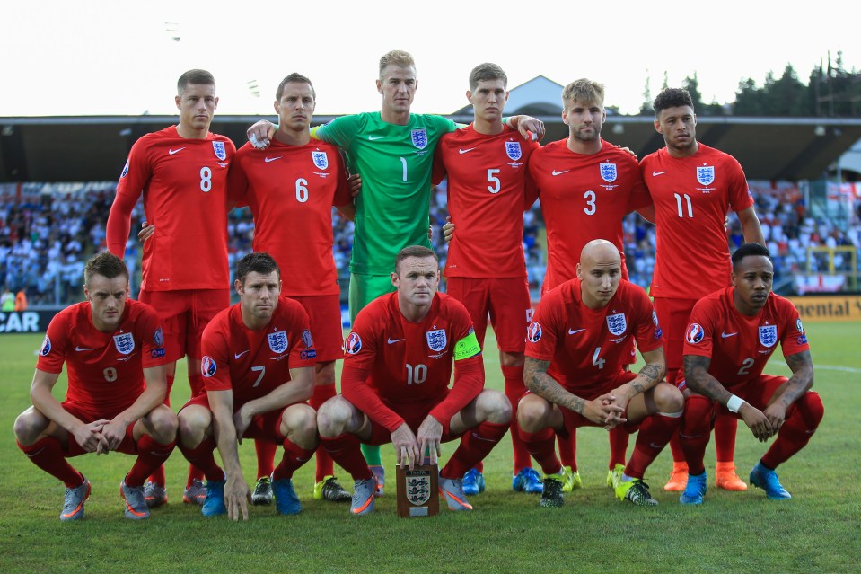 The England starting lineup, with six players standing in the back row and five crouching in front, posing for a team photo on a soccer field.