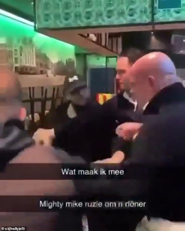 The three-time world champion darts player (right) is right at the centre of the scuffle