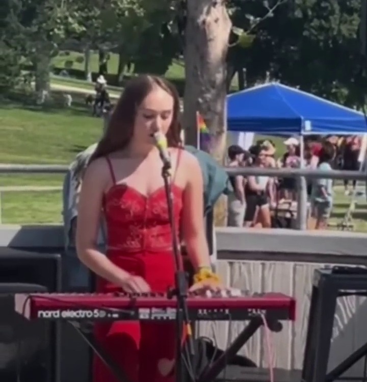 Chappell Roan performing at an outdoor event in a park.