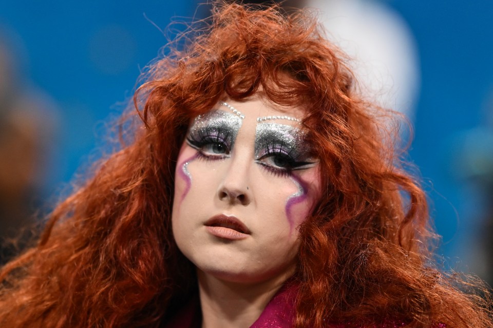 Chappell Roan with red hair and dramatic eye makeup.