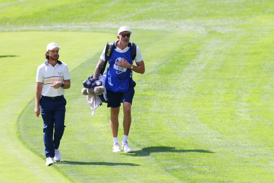 FARMINGDALE, NEW YORK - SEPTEMBER 28: Tommy Fleetwood of Team Europe walks on the second hole with his caddie, Ian Finnis during the Sunday singles matches of the 2025 Ryder Cup at Black Course at Bethpage State Park Golf Course on September 28, 2025 in Farmingdale, New York. (Photo by Mike Stobe/Getty Images)
