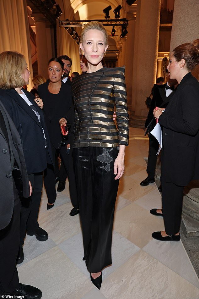 Cate wore a structured black and gold jacket with wide leg trousers