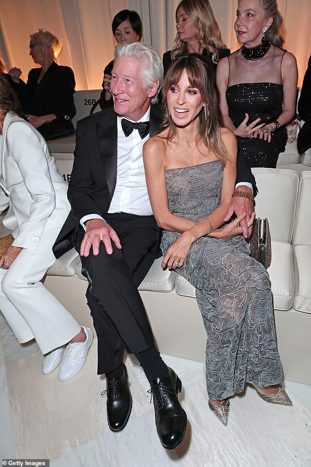 Richard Gere wrapped an arm around his wife Alejandra Silva as they took their seats