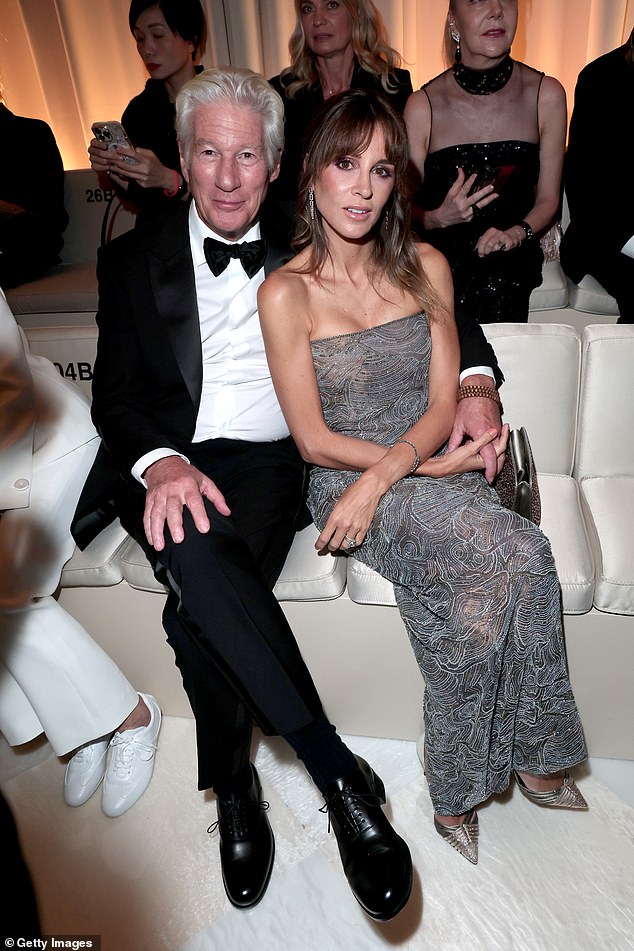 The Pretty Woman actor cut a dapper figure in a sharp black tuxedo as he sat front row with Alejandra for the star-studded show