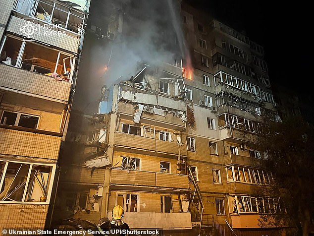 Firefighters work at the site of an overnight Russian attack in Kyiv on September 7