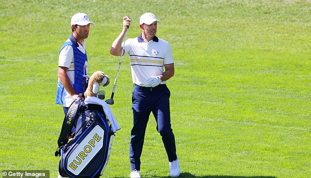FARMINGDALE, NEW YORK - SEPTEMBER 28: Rory McIlroy of Team Europe selects a club on the first hole alongside his caddie, Harry Diamond during the Sunday singles matches of the 2025 Ryder Cup at Black Course at Bethpage State Park Golf Course on September 28, 2025 in Farmingdale, New York. (Photo by Mike Stobe/Getty Images)