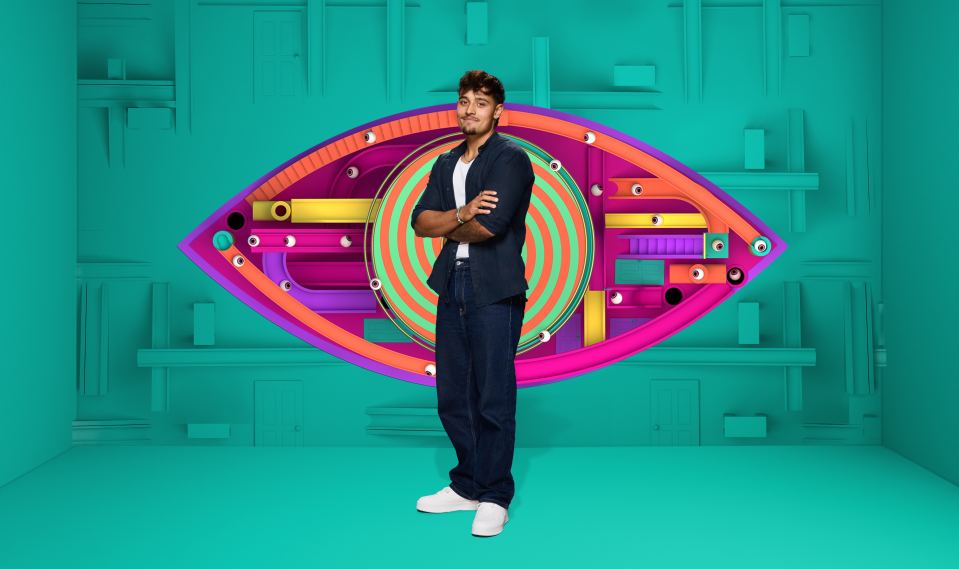 Zelah, a contestant on Big Brother, stands in front of a colorful eye-shaped logo.