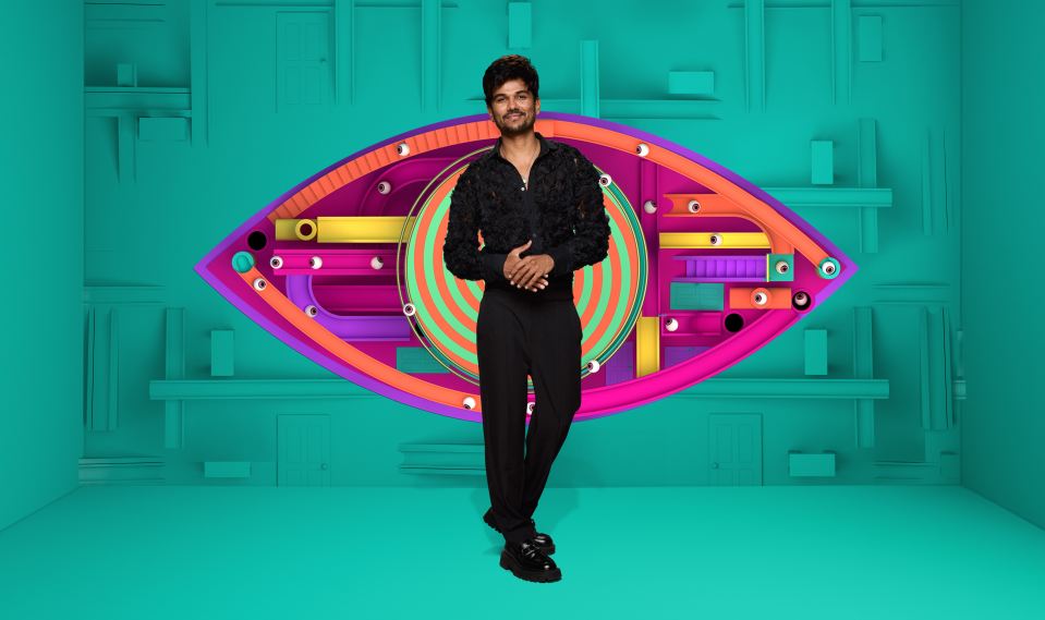 Gani in front of a colorful Big Brother eye logo.