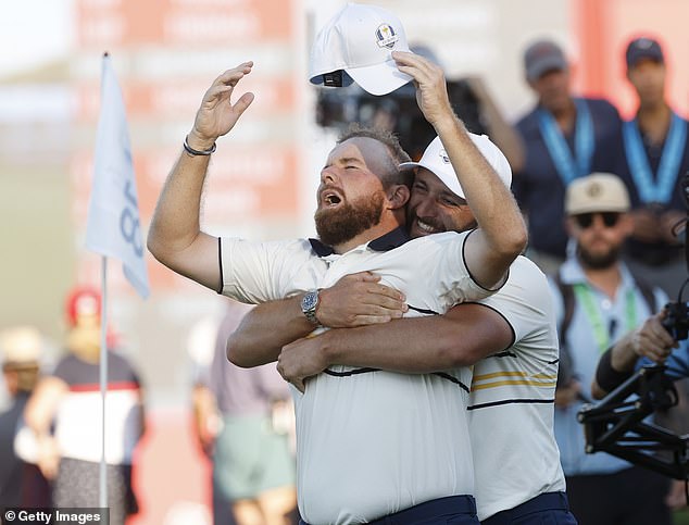 Jon Rahm embraced his teammate after they ensured the trophy is heading home with them