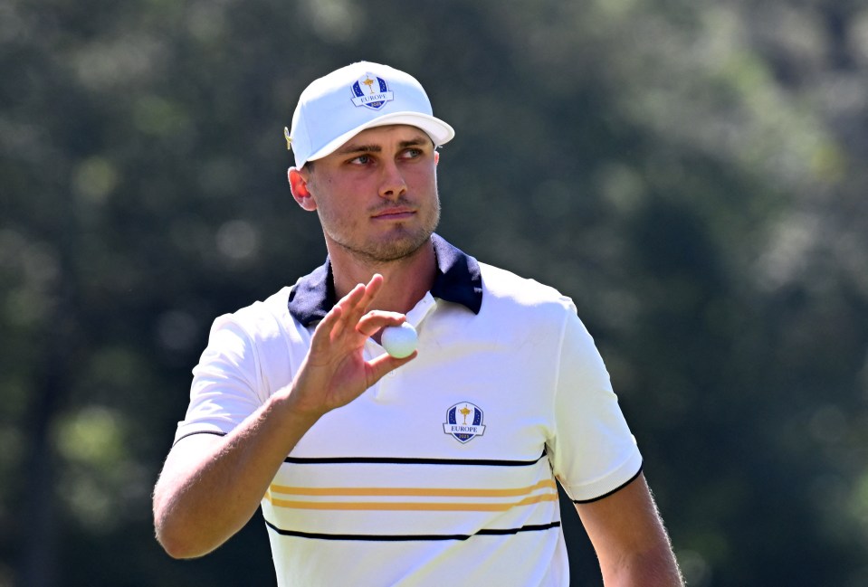 Ludvig Aberg reacts with a golf ball during a Ryder Cup singles match.