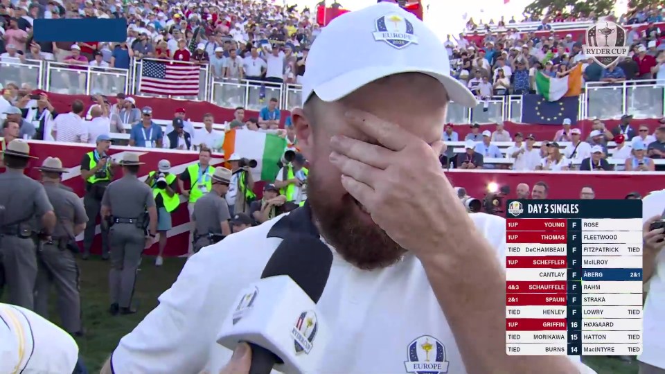Shane Lowry crying and covering his face with his hand while being interviewed at the Ryder Cup.