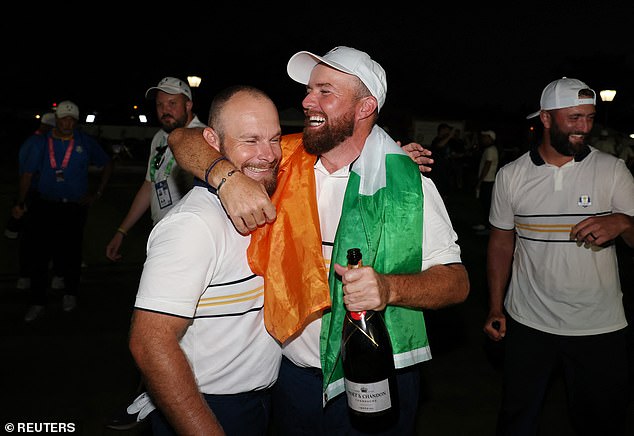 Lowry got the half point to retain the Ryder Cup, before Tyrrell Hatton (left) sealed the win