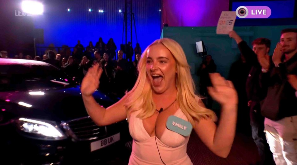 Emily from Big Brother waving to the audience.