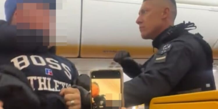Shocking moment boozy Brit stag do yobs are dragged off Ryanair flight by armed cops after emergency landing