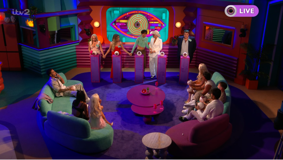 Big Brother UK live broadcast in a colorful studio.