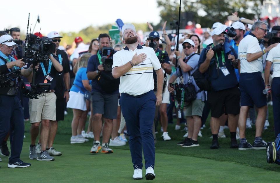 Shane Lowry of Team Europe reacts after his putt to halve the hole and retain the Ryder Cup.