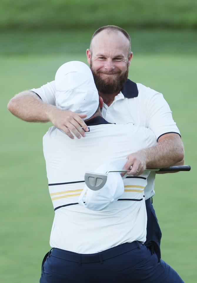 Shane Lowry lifts teammate Tyrrell Hatton after Hatton halved his match to win the Ryder Cup.